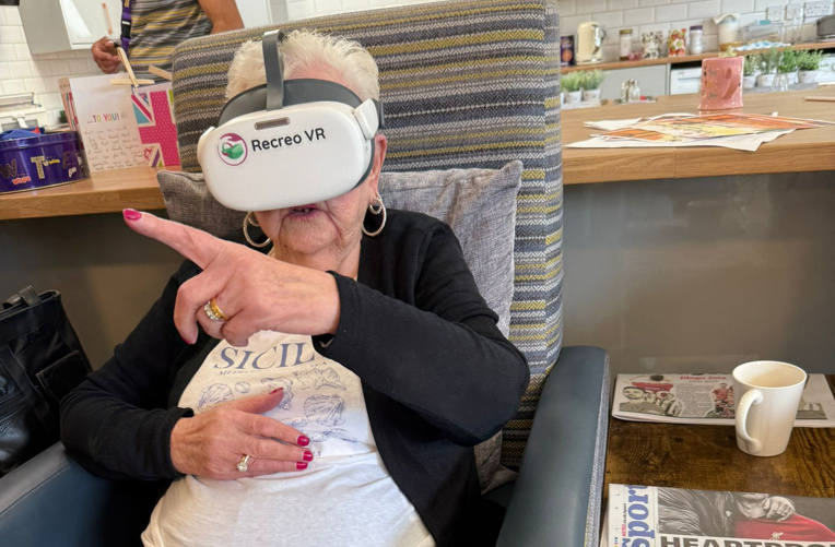 Older woman using Recreo virtual reality headset in Solihull day facility